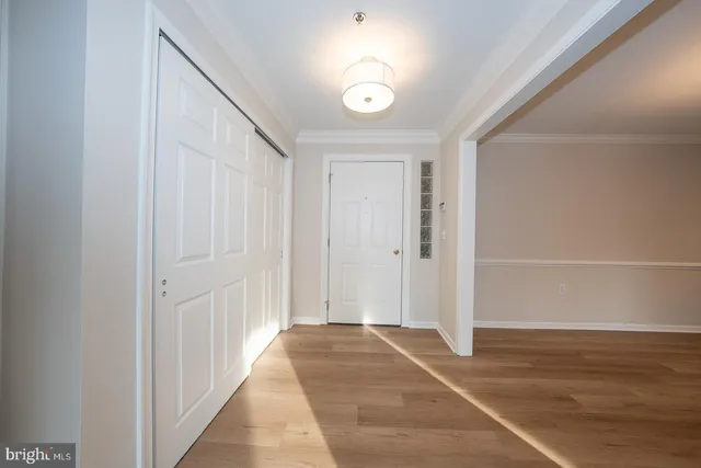 a kitchen with sink a microwave and cabinets