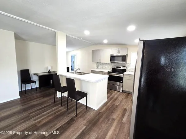 a kitchen with a sink stainless steel appliances and cabinets