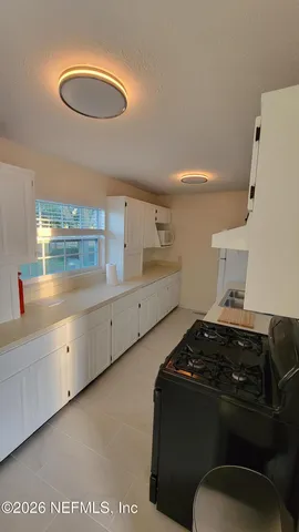 a kitchen with sink and cabinets