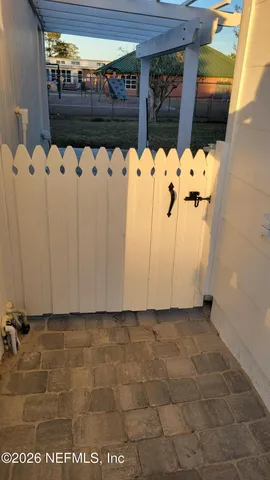 a backyard of a house with table and chairs