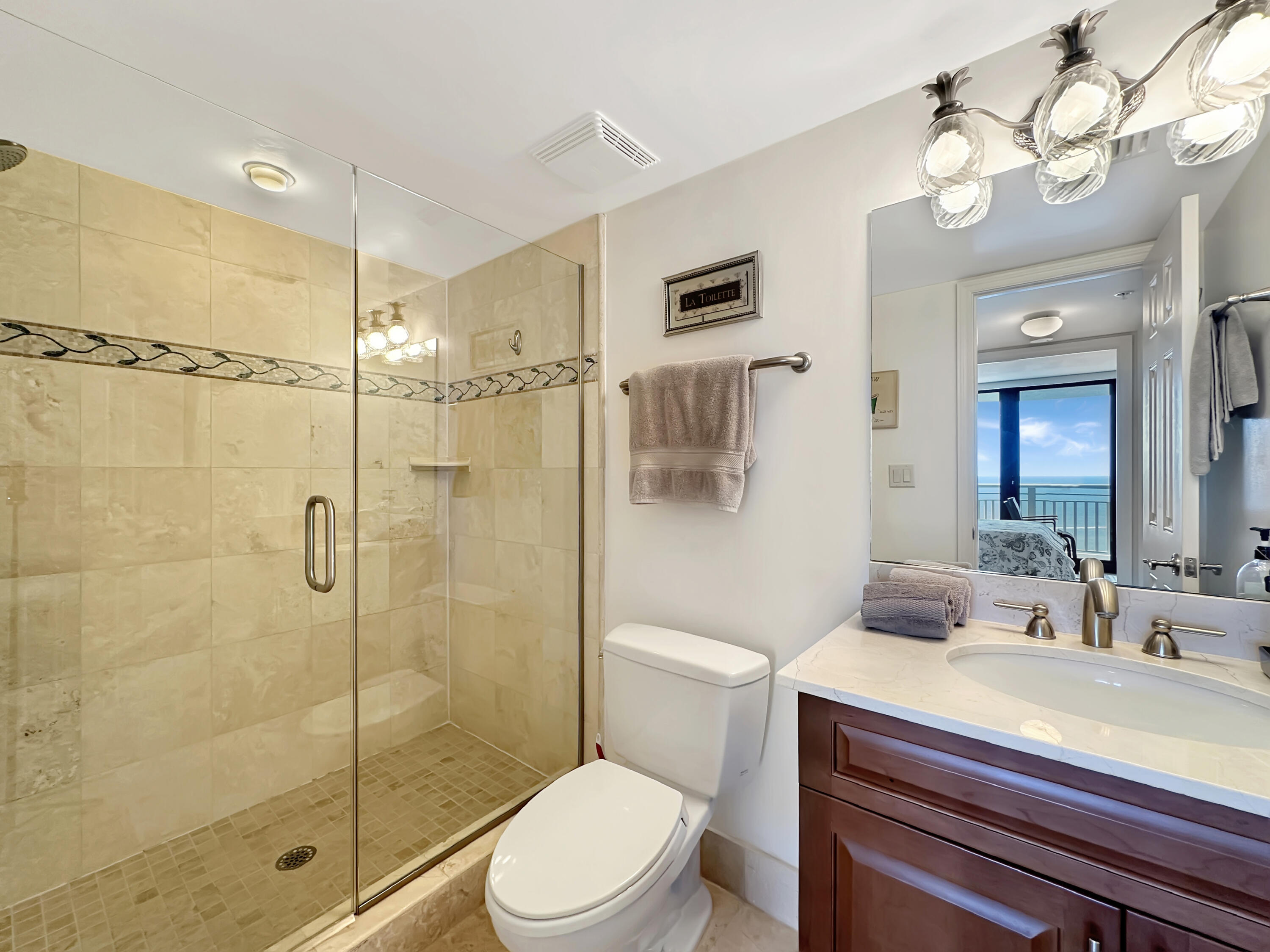 3000 North Ocean Drive, Unit 40E Riviera Beach, FL 33404 - Photo 11 of 50 a bathroom with a sink a toilet and shower