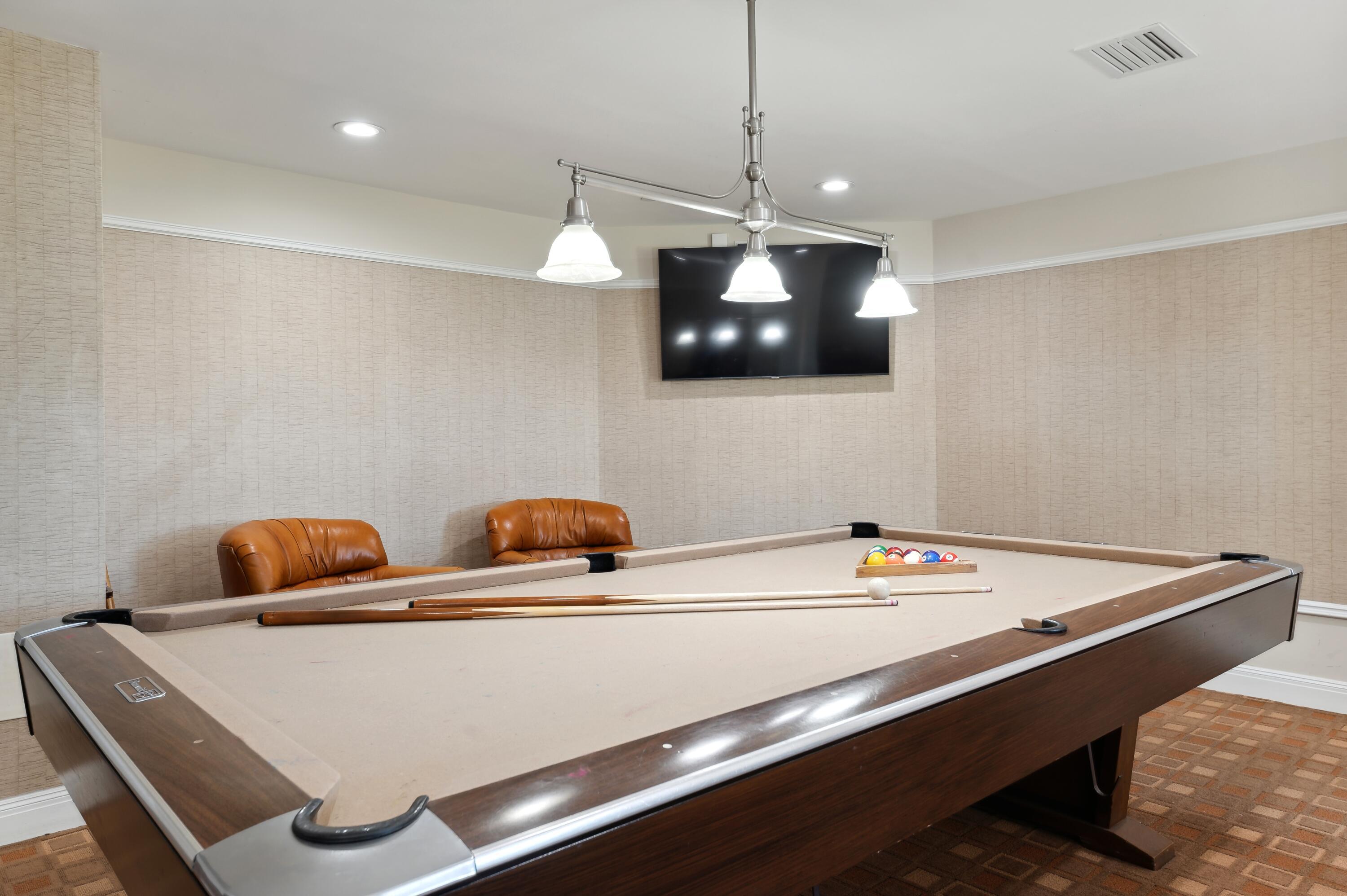 3000 North Ocean Drive, Unit 40E Riviera Beach, FL 33404 - Photo 19 of 50 a room with pool table and a flat screen tv