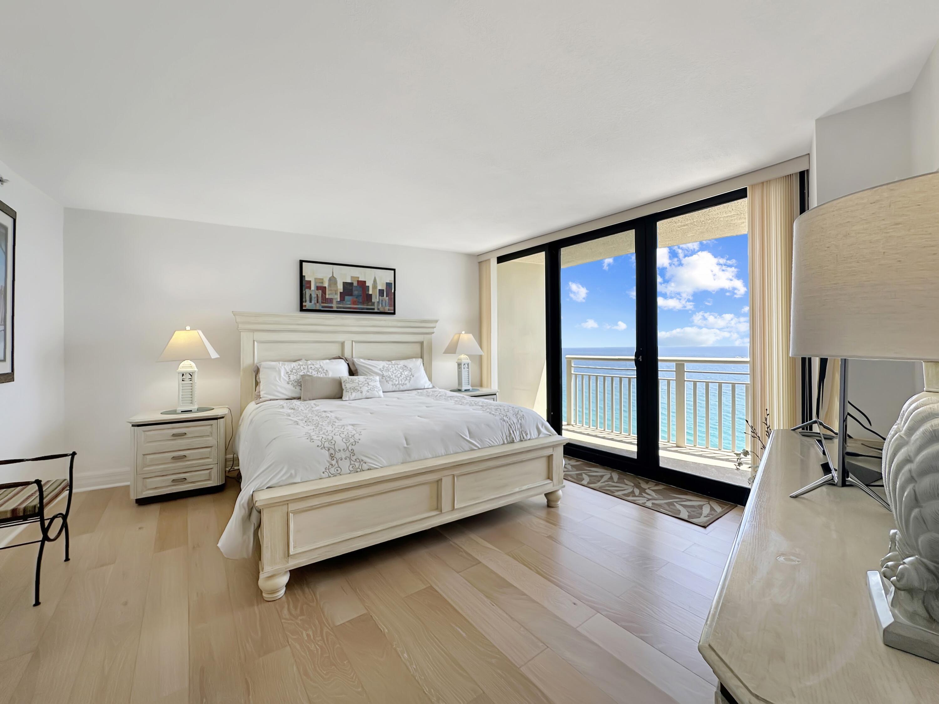 3000 North Ocean Drive, Unit 40E Riviera Beach, FL 33404 - Photo 7 of 50 a bedroom with a large bed and a large window