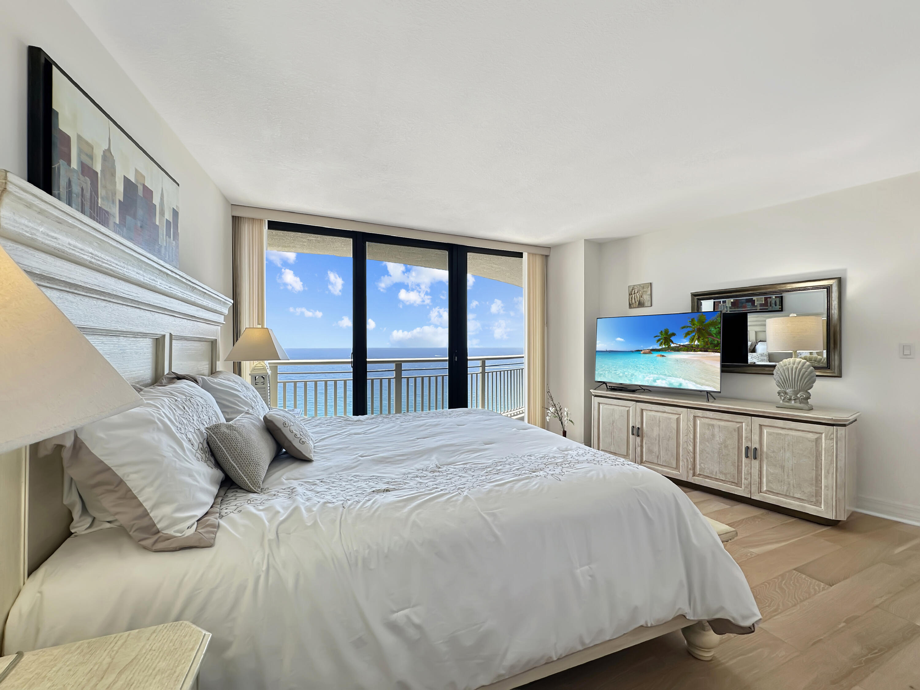 3000 North Ocean Drive, Unit 40E Riviera Beach, FL 33404 - Photo 8 of 50 a bedroom with a large bed and two large window