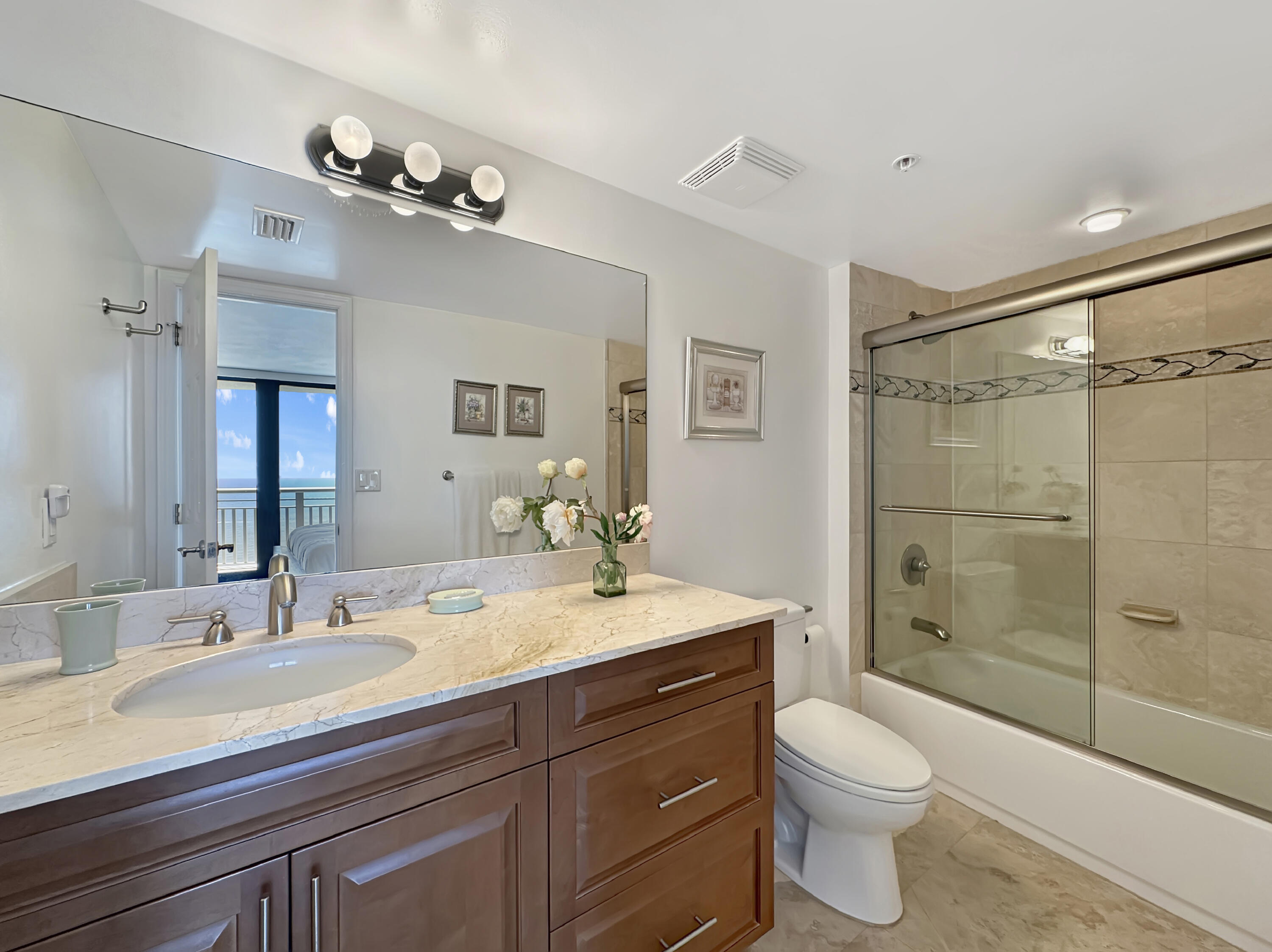 3000 North Ocean Drive, Unit 40E Riviera Beach, FL 33404 - Photo 9 of 50 a bathroom with a sink a toilet and shower