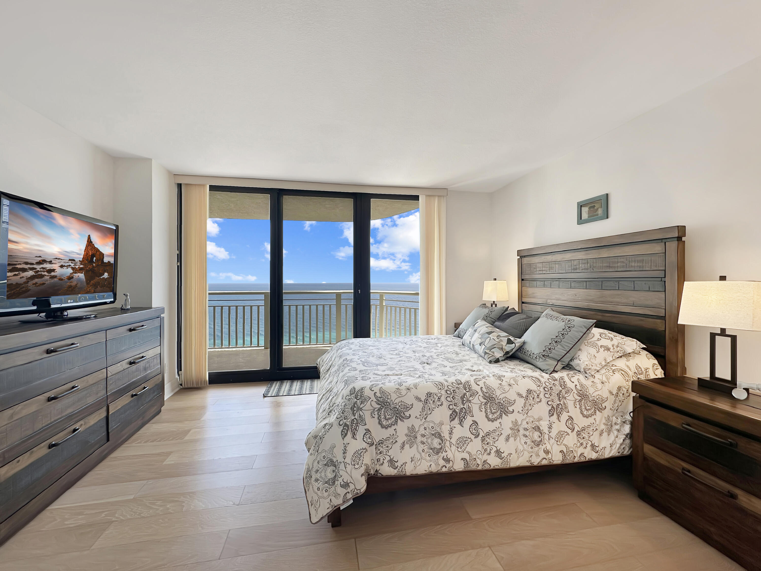 3000 North Ocean Drive, Unit 40E Riviera Beach, FL 33404 - Photo 10 of 50 a bedroom with a bed and a flat screen tv