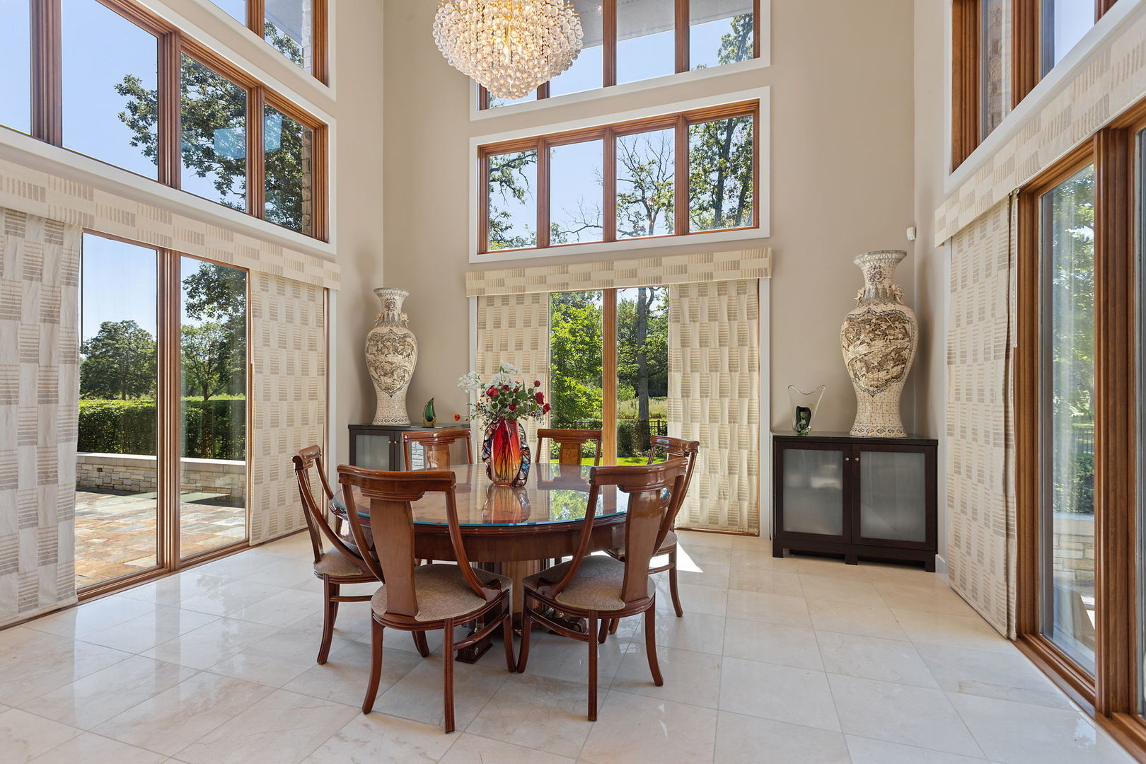 925 Morrison Road Northbrook, IL 60062 - Photo 19 of 75 a dining room with furniture a rug a potted plant and a painting on the wall