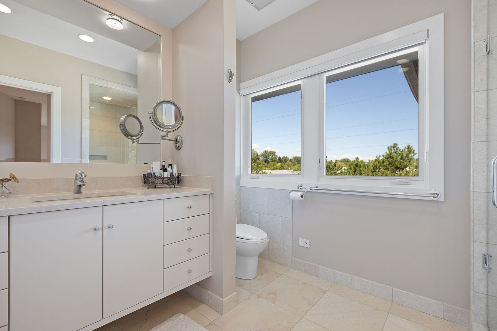 925 Morrison Road Northbrook, IL 60062 - Photo 57 of 75 a bathroom with a double vanity sink toilet and a window