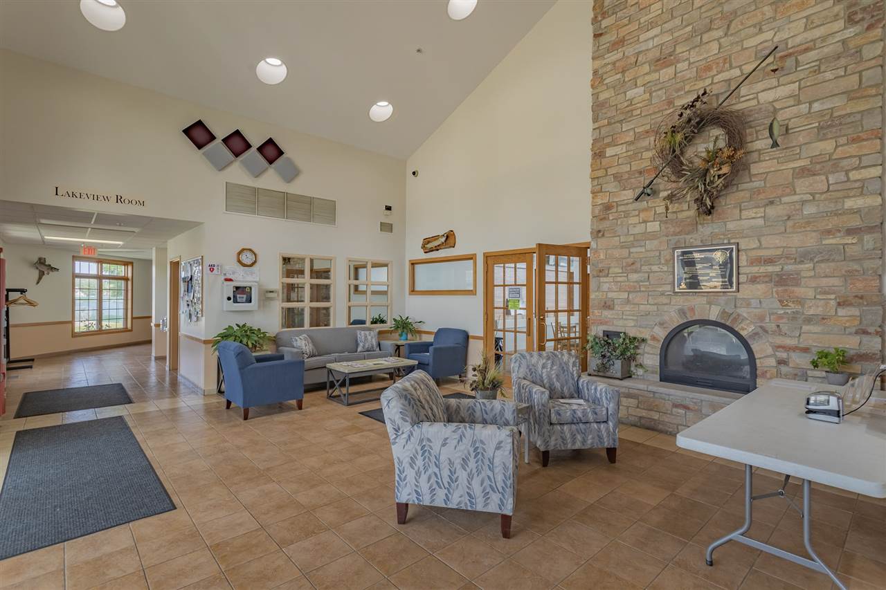 208 New Forest Road Southwest Poplar Grove, IL 61065 - Photo 34 of 40 a living room with fireplace furniture and a rug
