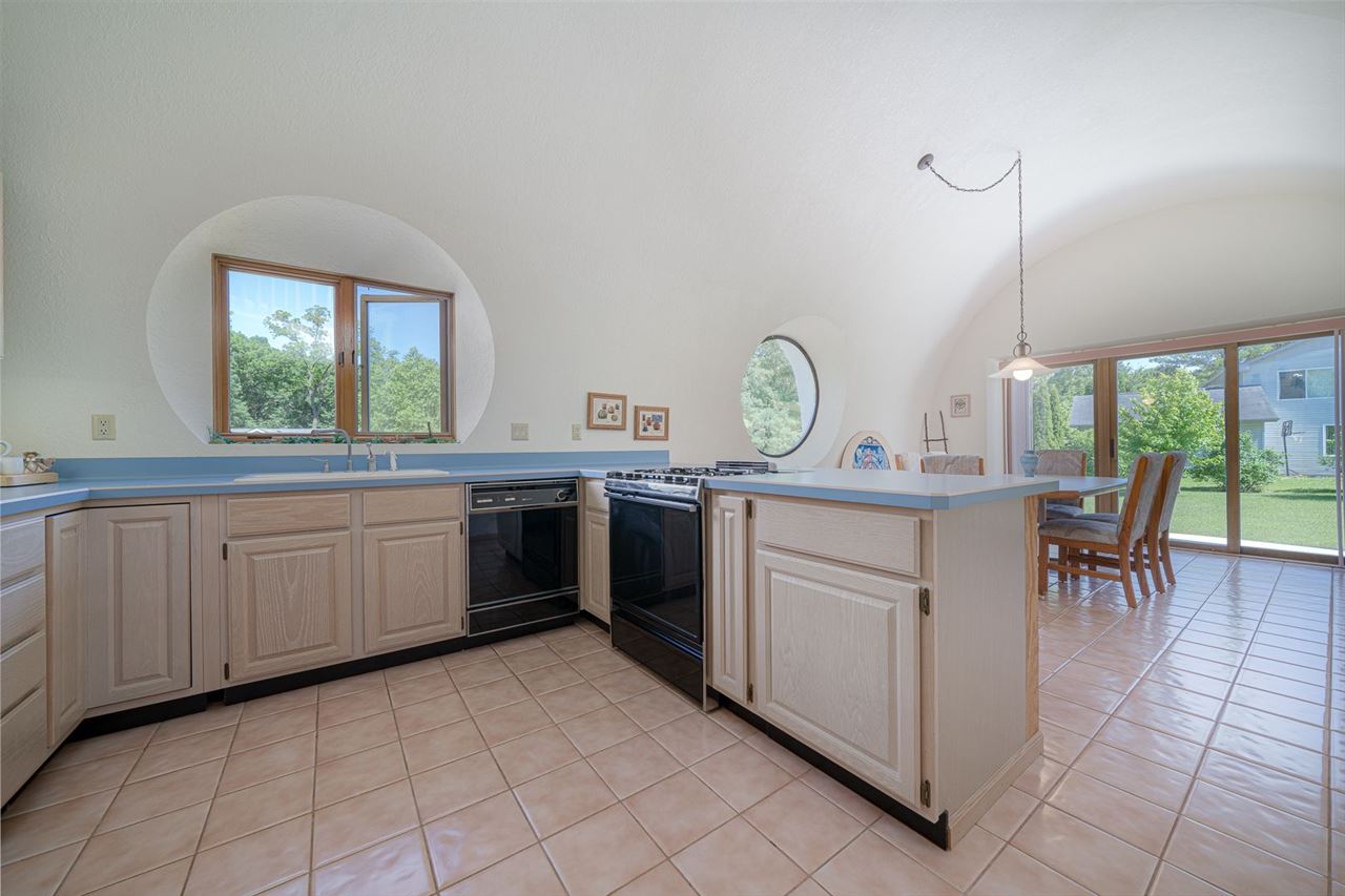 208 New Forest Road Southwest Poplar Grove, IL 61065 - Photo 8 of 40 a kitchen with a stove a sink and a window