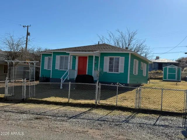 a view of a house with a backyard