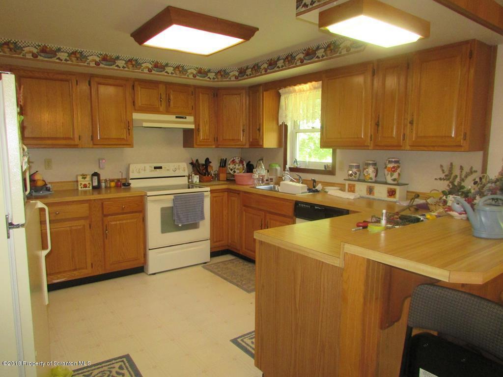 91 Turkey Path Road Wyalusing, PA 18853 - Photo 3 of 22 a kitchen with a sink a stove and cabinets