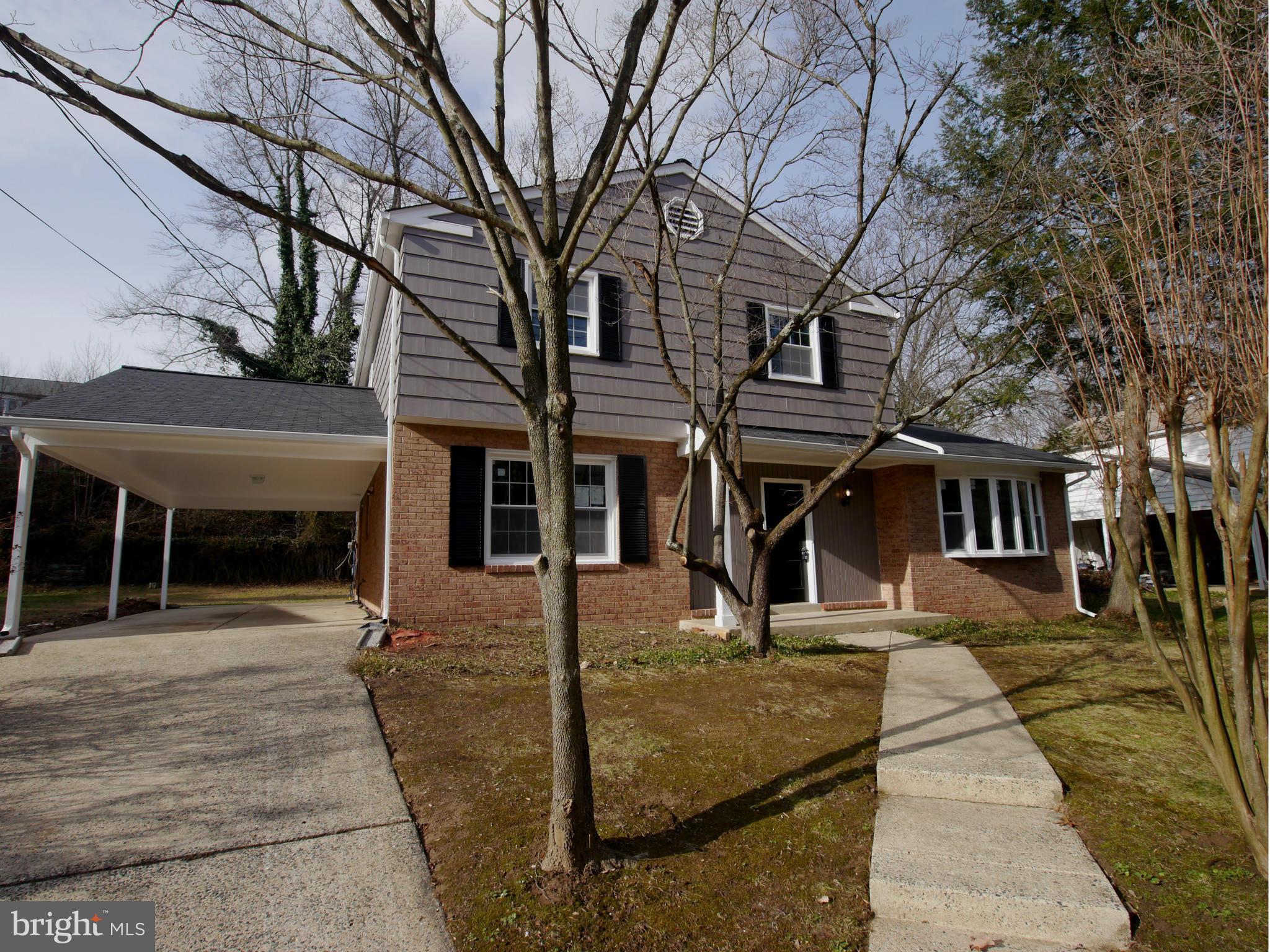 13100 Middlevale Lane Silver Spring, MD 20906 - Photo 1 of 30 a front view of a house with a garden