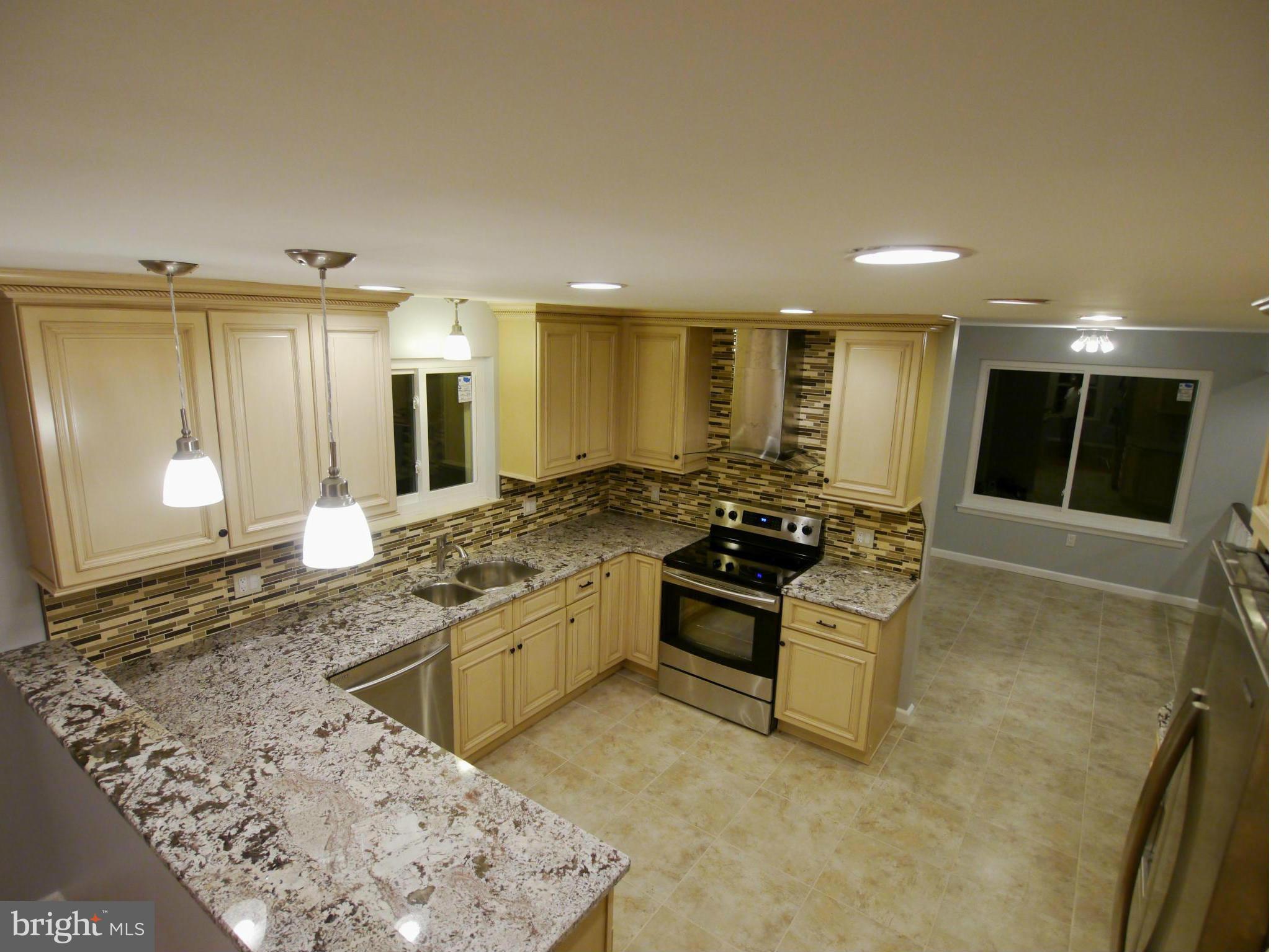 13100 Middlevale Lane Silver Spring, MD 20906 - Photo 2 of 30 a kitchen with stainless steel appliances granite countertop a sink and a stove