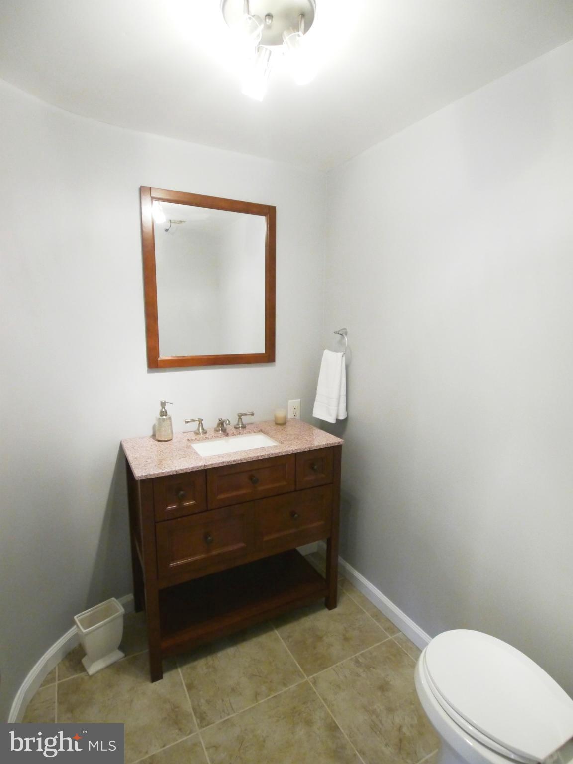 13100 Middlevale Lane Silver Spring, MD 20906 - Photo 16 of 30 a bathroom with a toilet a sink and mirror