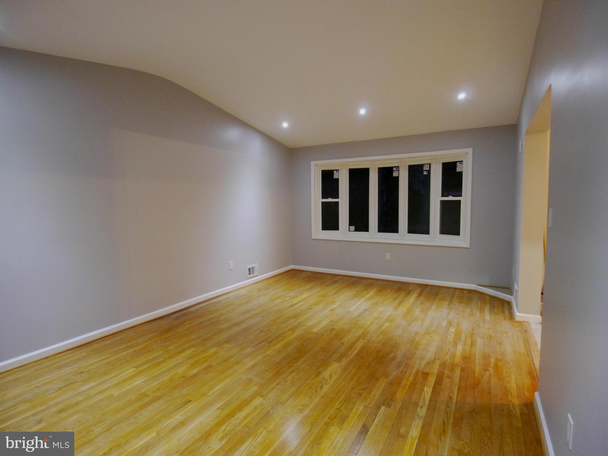 13100 Middlevale Lane Silver Spring, MD 20906 - Photo 17 of 30 a view of an empty room with wooden floor and a window