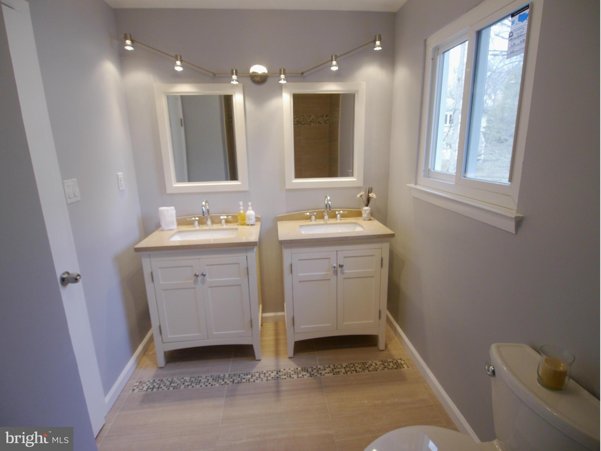 13100 Middlevale Lane Silver Spring, MD 20906 - Photo 22 of 30 a bathroom with a sink and a mirror