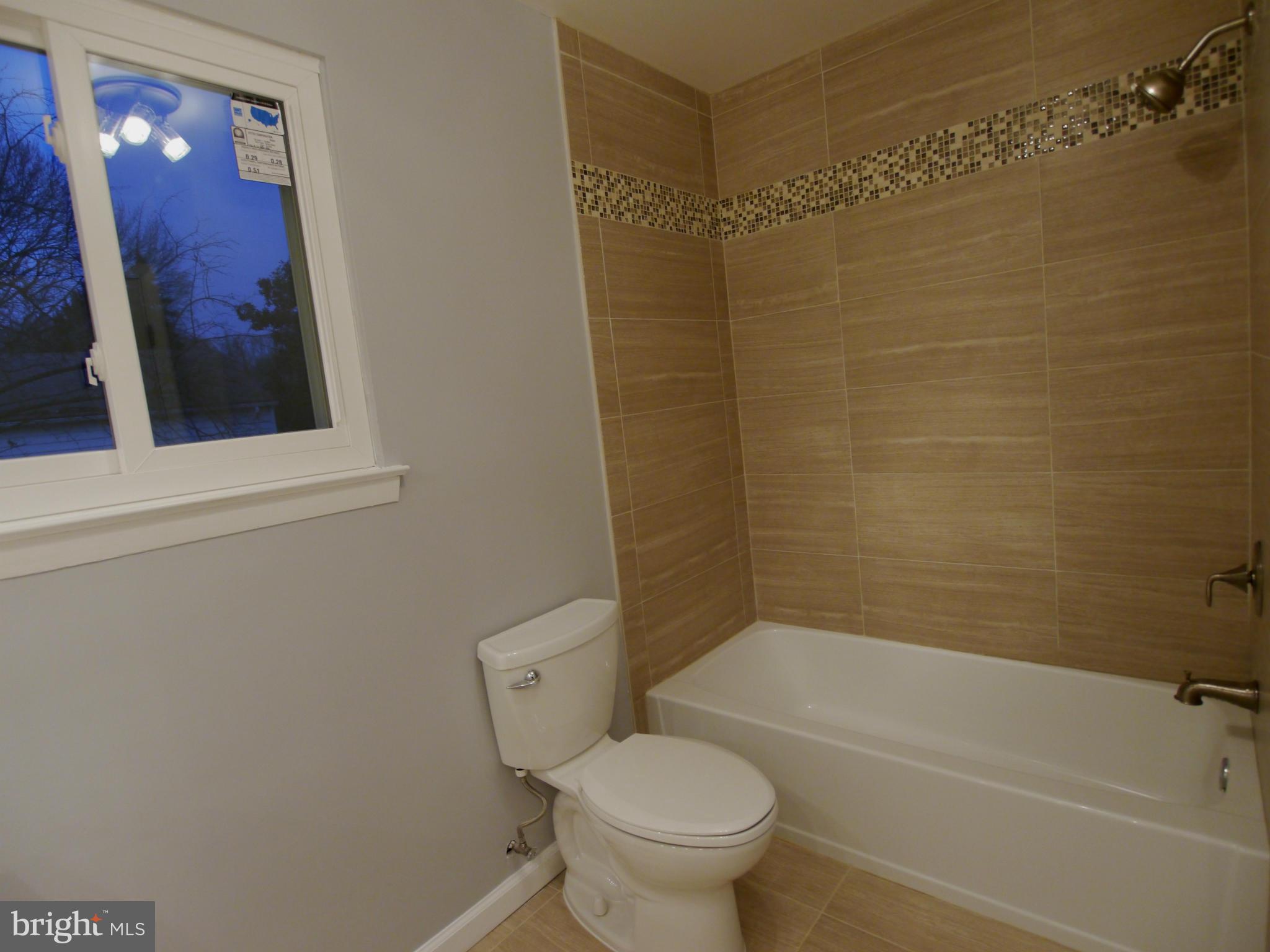 13100 Middlevale Lane Silver Spring, MD 20906 - Photo 23 of 30 a bathroom with a toilet and a bathtub