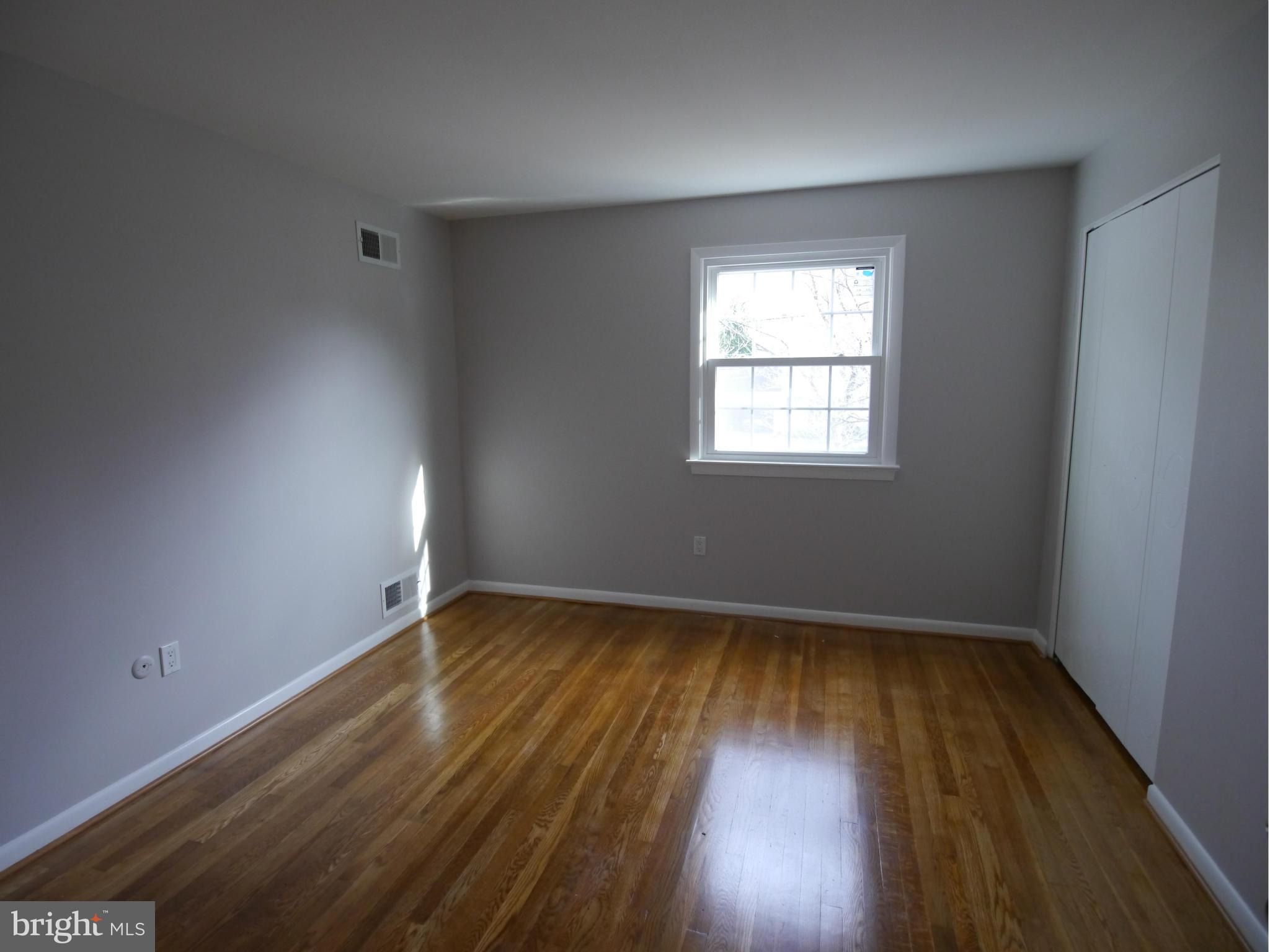 13100 Middlevale Lane Silver Spring, MD 20906 - Photo 24 of 30 an empty room with wooden floor and windows