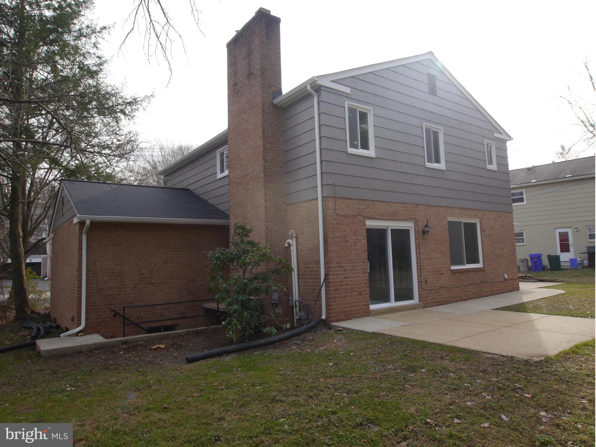 13100 Middlevale Lane Silver Spring, MD 20906 - Photo 27 of 30 a front view of house with yard and trees in the background