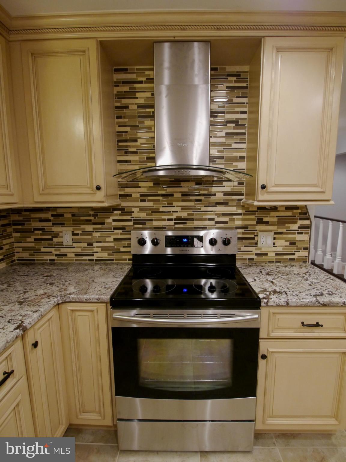 13100 Middlevale Lane Silver Spring, MD 20906 - Photo 4 of 30 a kitchen with granite countertop a stove and a sink