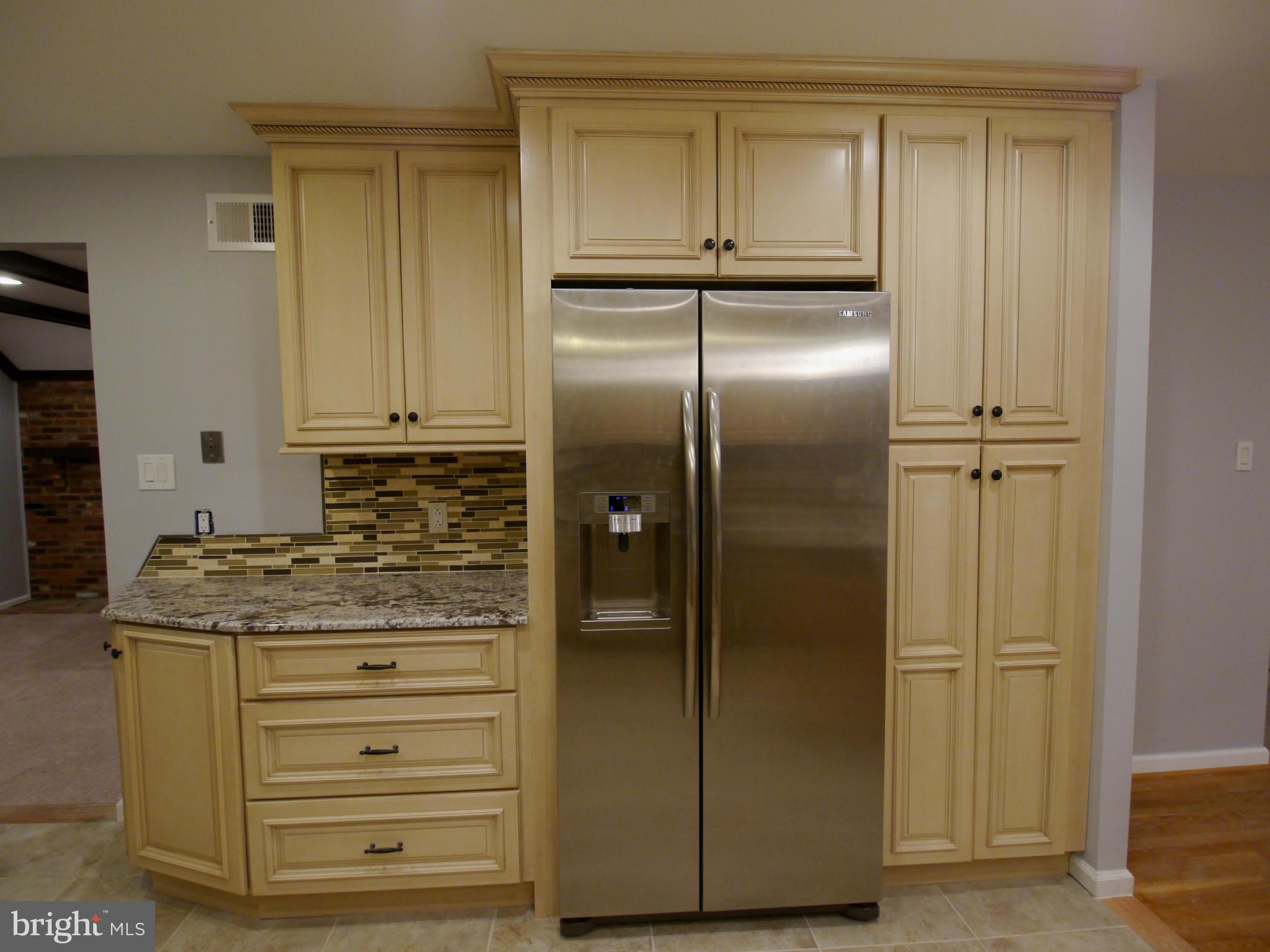 13100 Middlevale Lane Silver Spring, MD 20906 - Photo 6 of 30 a kitchen with stainless steel appliances granite countertop cabinets and refrigerator