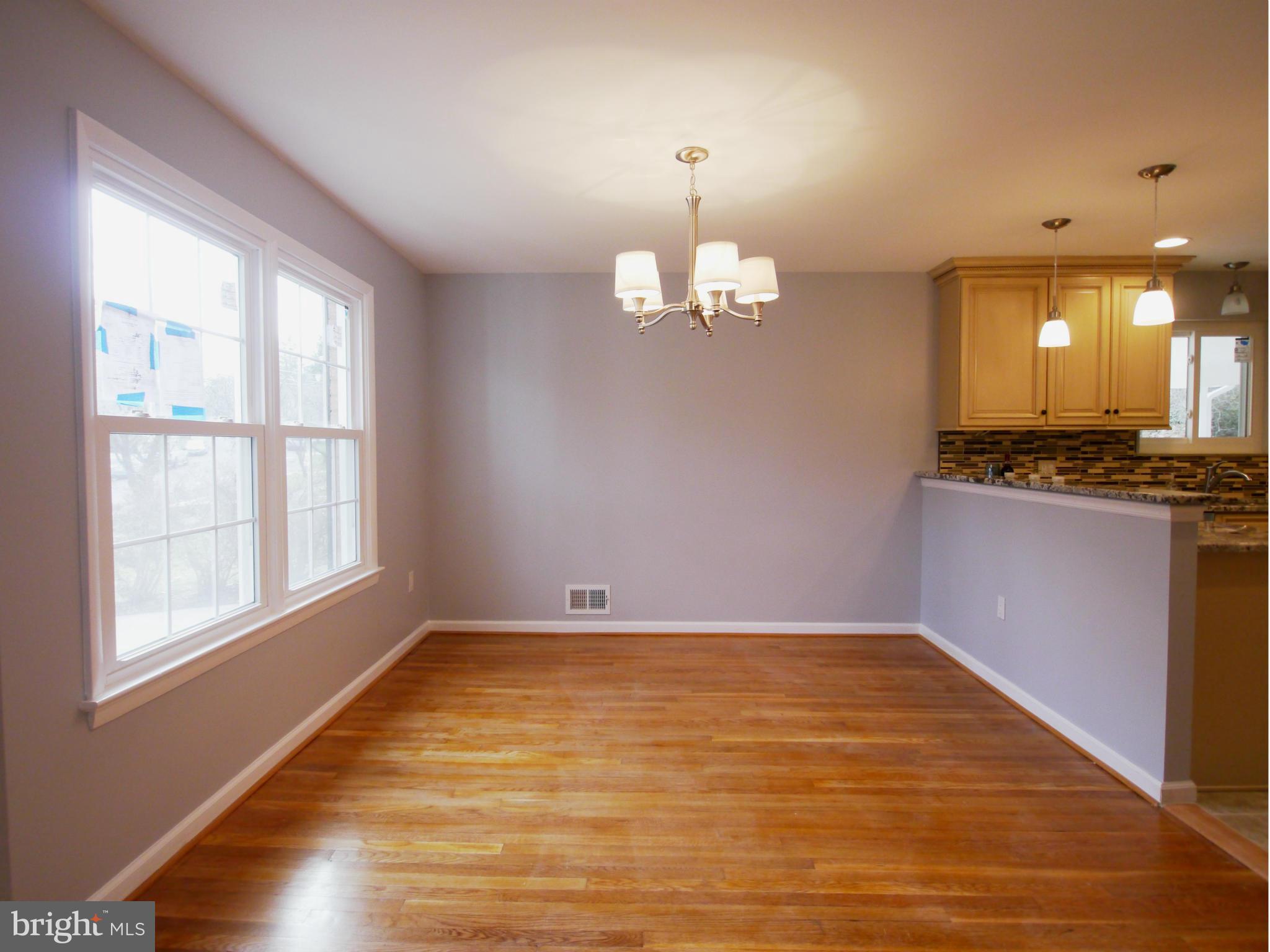 13100 Middlevale Lane Silver Spring, MD 20906 - Photo 9 of 30 an empty room with wooden floor and windows