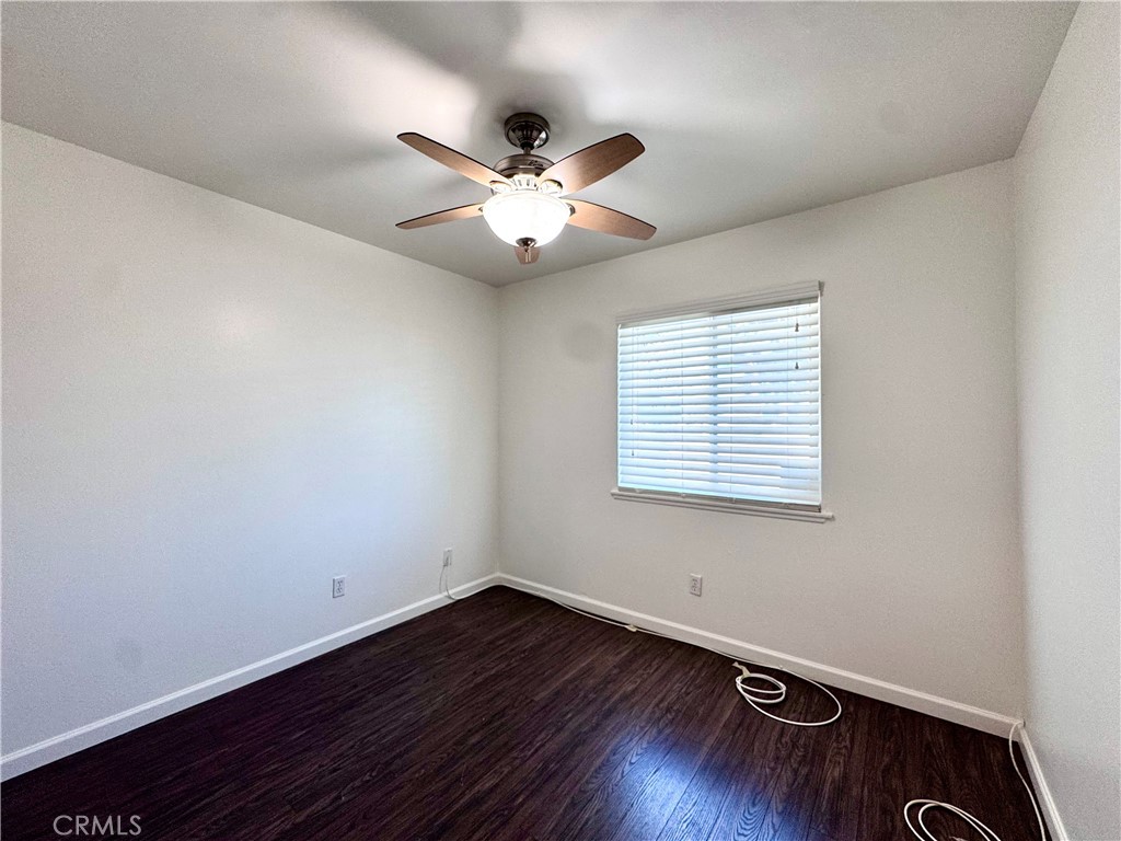 4692 Heil Avenue Huntington Beach, CA 92649 - Photo 16 of 27 a view of an empty room with wooden floor and a window