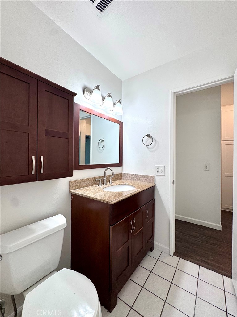 4692 Heil Avenue Huntington Beach, CA 92649 - Photo 7 of 27 a bathroom with a sink vanity granite and toilet