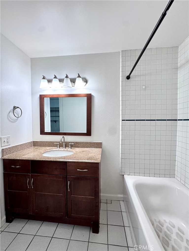 4692 Heil Avenue Huntington Beach, CA 92649 - Photo 9 of 27 a bathroom with a tub sink and mirror