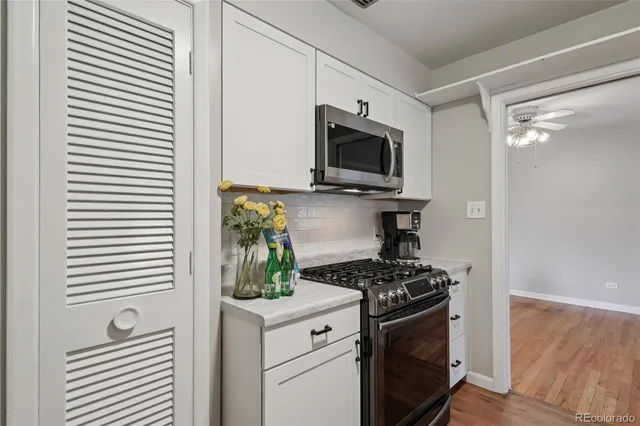 a kitchen with stainless steel appliances a stove a microwave and cabinets