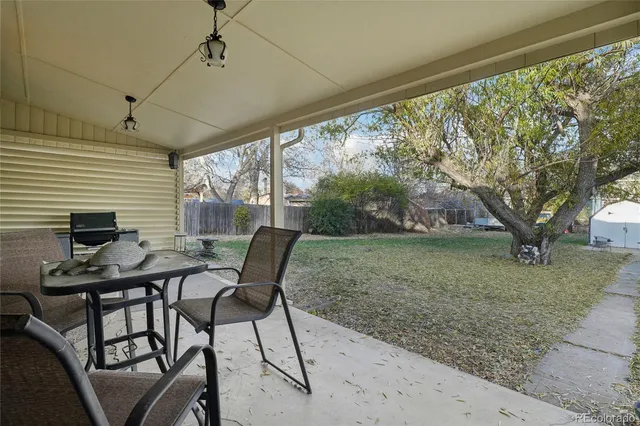 a view of a porch with furniture and a yard