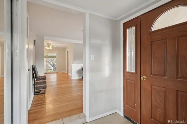 a view of a hallway with wooden floor windows and a livingroom