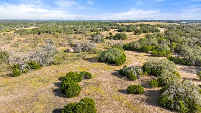 a view of a yard with wooden fence