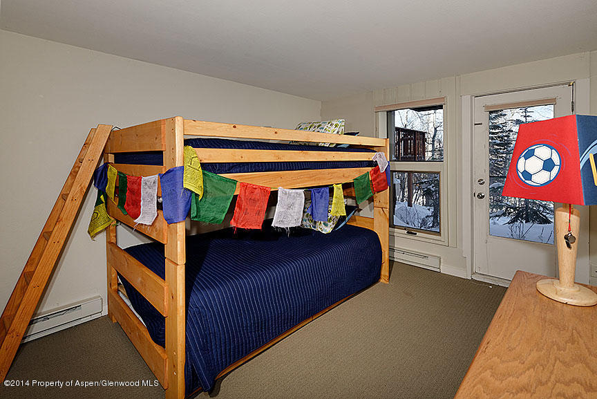 47 North Ridge Lane, Unit B Snowmass Village, CO 81615 - Photo 11 of 18 a bedroom with a bed and a dresser