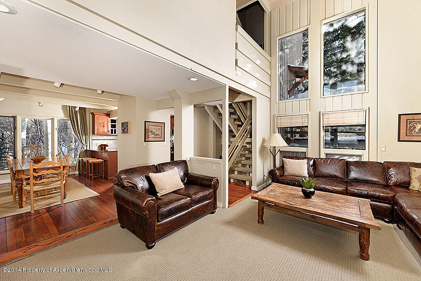 47 North Ridge Lane, Unit B Snowmass Village, CO 81615 - Photo 2 of 18 a living room with furniture fireplace and flat screen tv