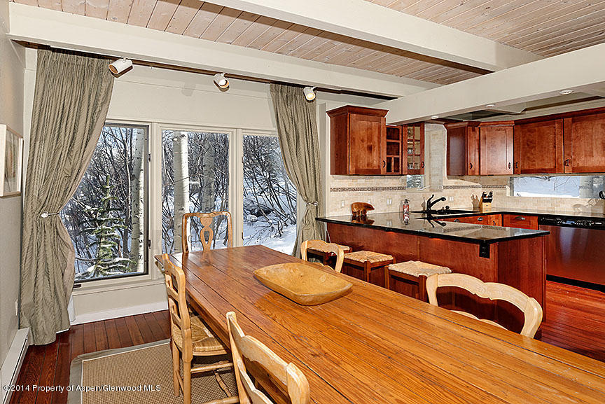 47 North Ridge Lane, Unit B Snowmass Village, CO 81615 - Photo 5 of 18 a dining room with wooden floor and large window