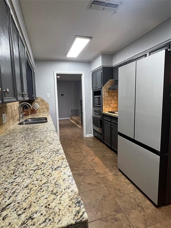 3802 Chisholm Trail Temple, TX 76504 - Photo 5 of 23 a kitchen with granite countertop a refrigerator and a sink