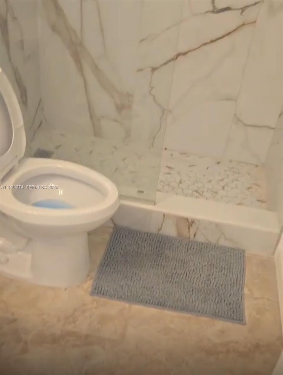 2501 Riverside Drive, Unit 402A Coral Springs, FL 33065 - Photo 8 of 9 a bathroom with a toilet a sink and a bathtub