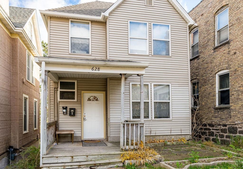628 West 3rd Street Duluth, MN 55806 - Photo 8 of 8 Traditional home with a wooden deck and roof with shingles