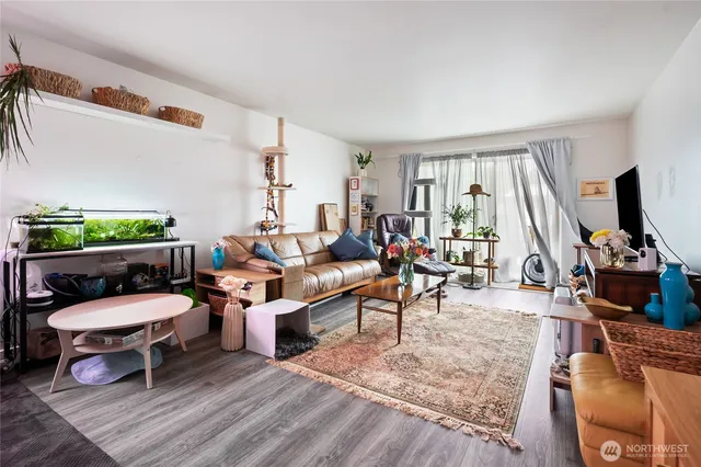 a living room with furniture a rug and a flat screen tv