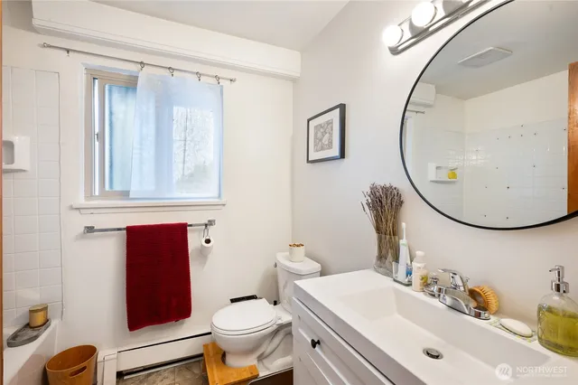 a bathroom with a sink mirror and toilet
