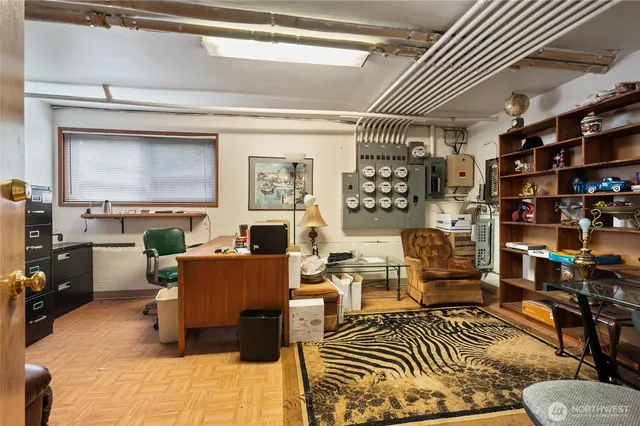 a living room with furniture a rug and a bookshelf