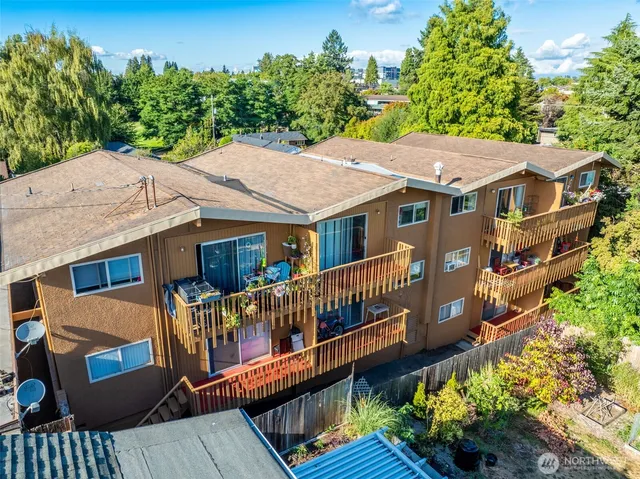 an aerial view of a house with a deck and furniture