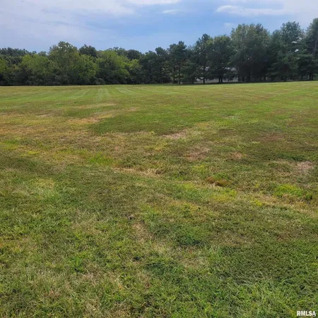a view of a lake with houses in the back