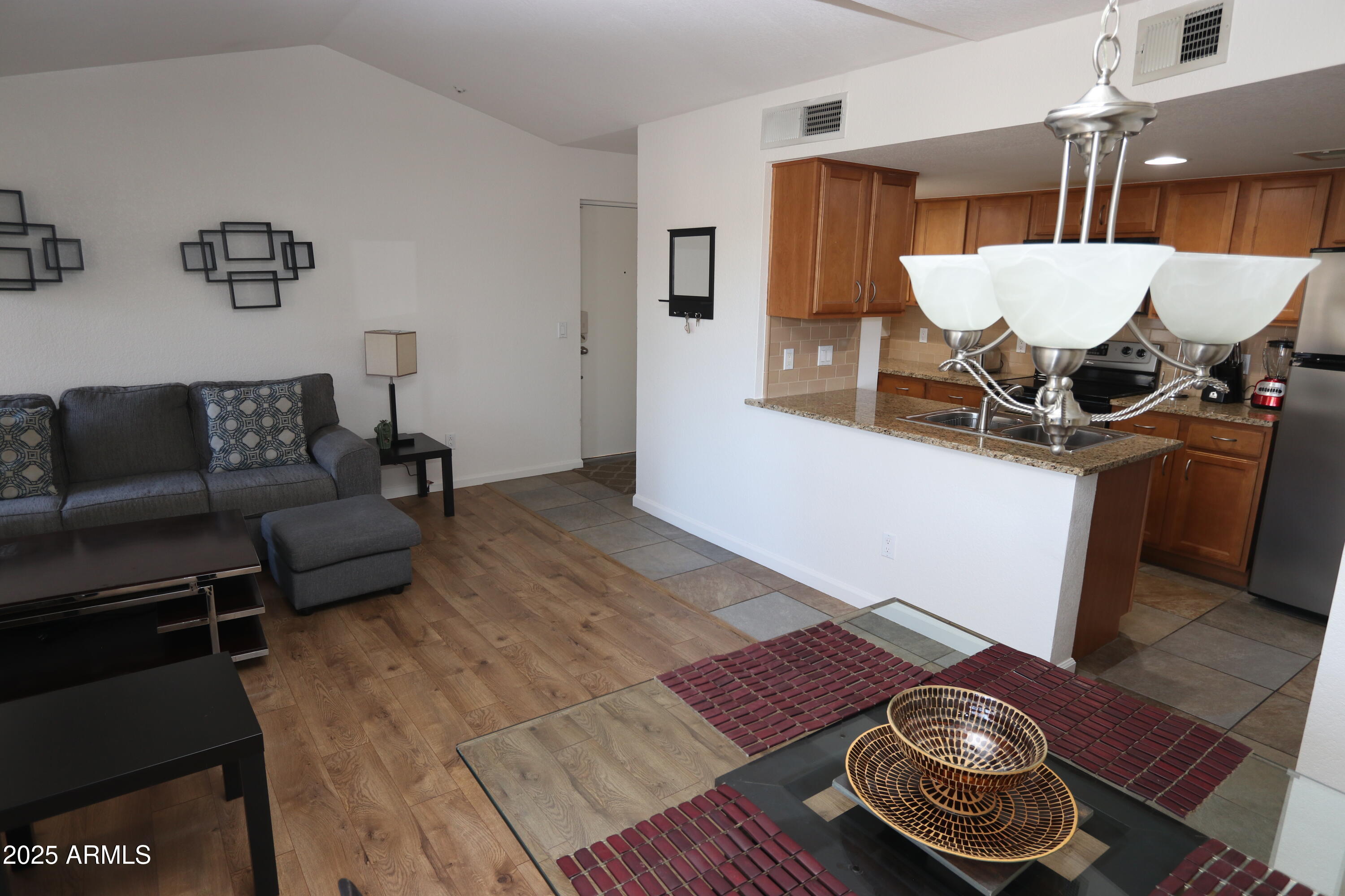 200 East Southern Avenue, Unit 307 Tempe, AZ 85282 - Photo 12 of 16 a living room with furniture and wooden floor