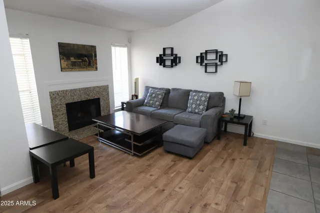a living room with furniture and a fireplace