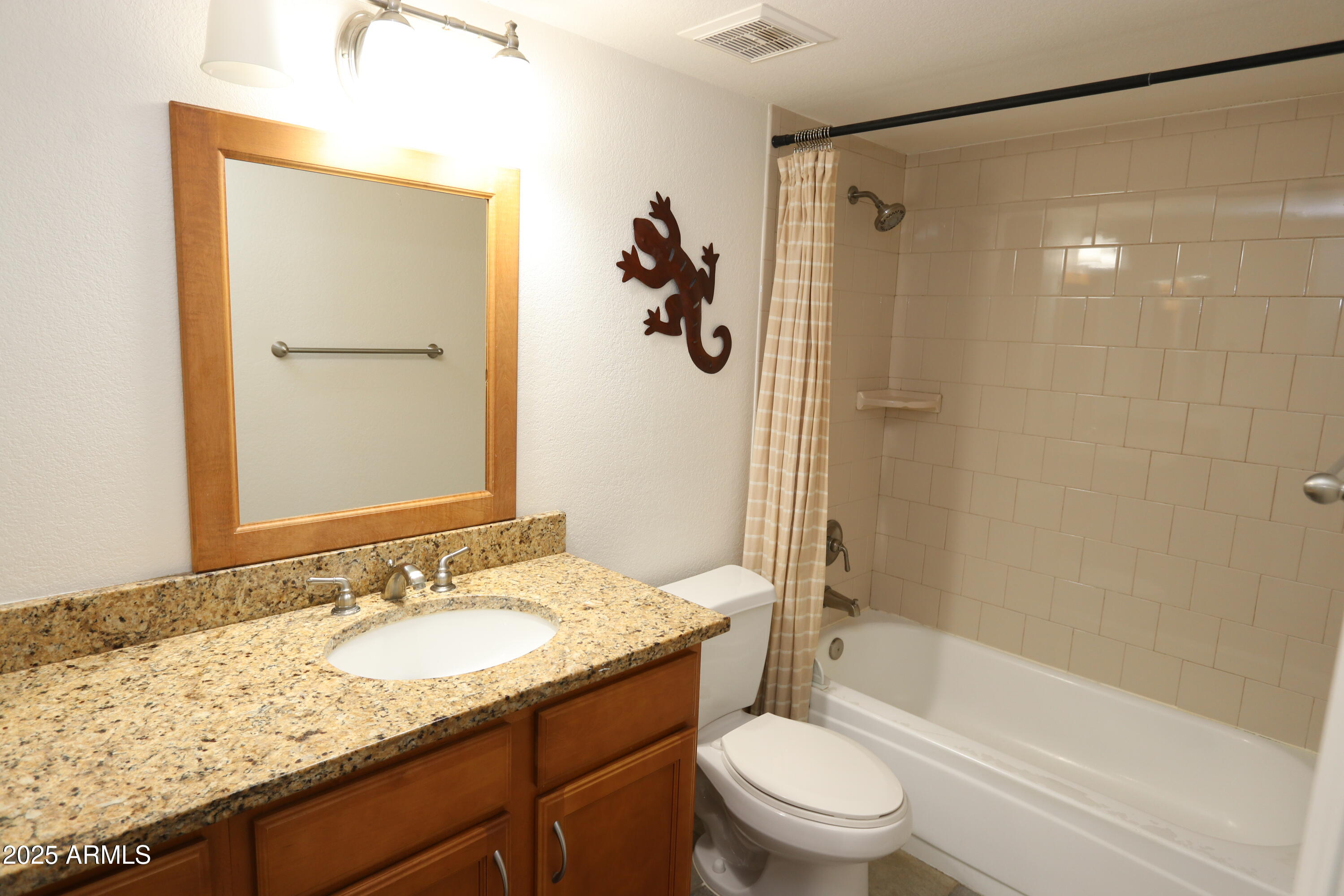 200 East Southern Avenue, Unit 307 Tempe, AZ 85282 - Photo 14 of 16 a bathroom with a granite countertop sink toilet and shower