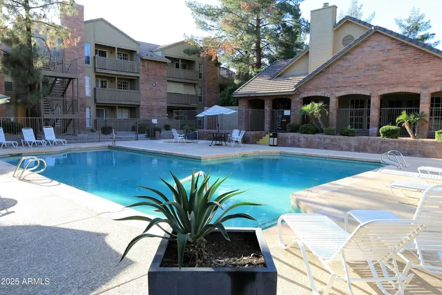 a view of a house with swimming pool and sitting area