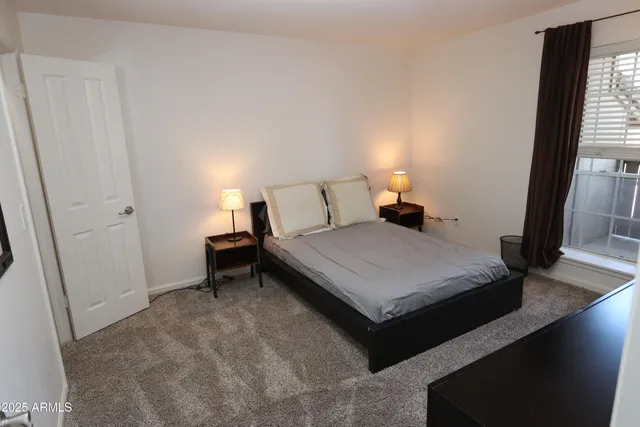 a bed room with a bed and a window